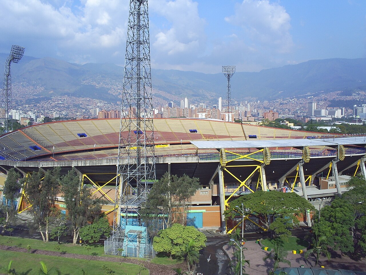 Exterior view of Atanasio Girardot Stadium with the city of Medellín behind