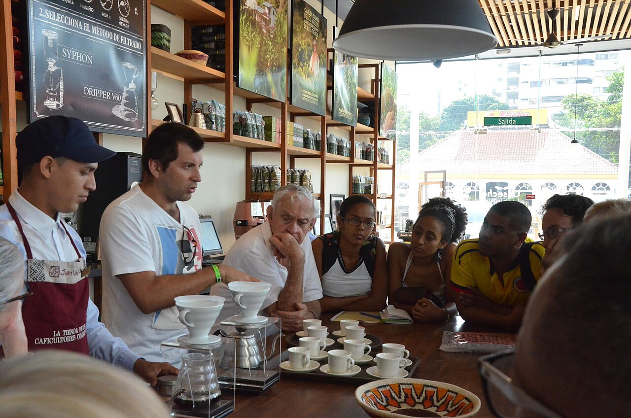 A barista brewing drip coffee at a Juan Valdez coffee shop in Colombia