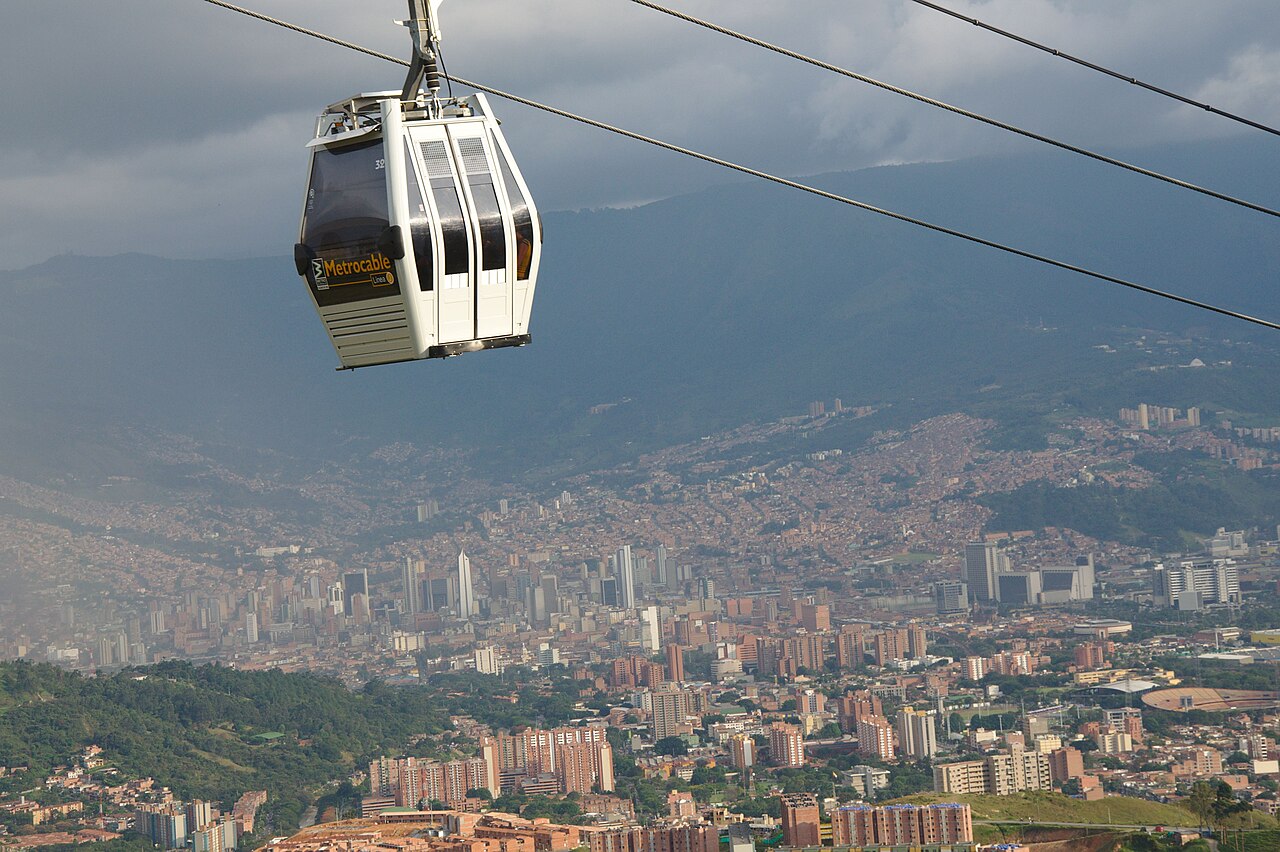 Metrocable cabin high above Medellín with the city centre behind