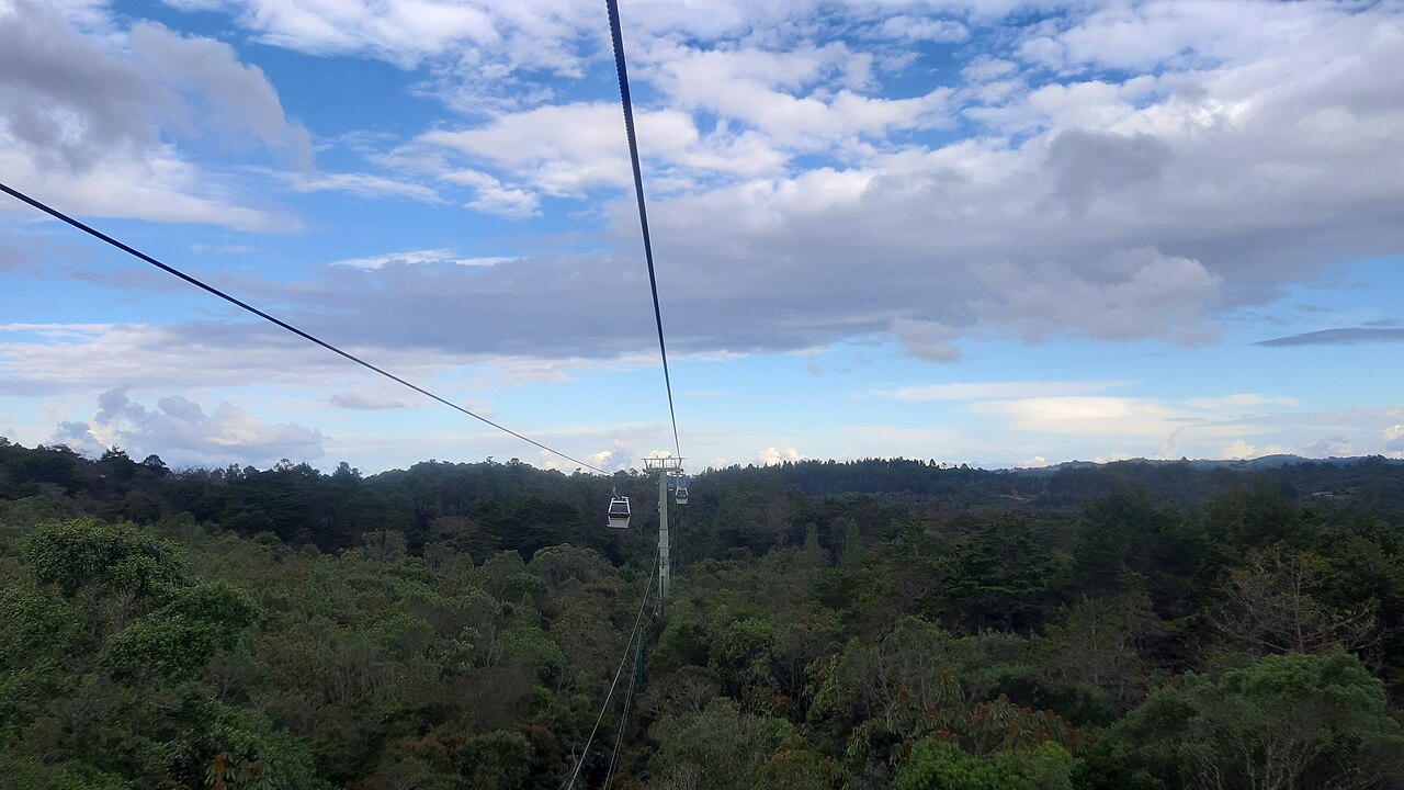 Metrocable cable car cabins heading to Parque Arvi above Medellin