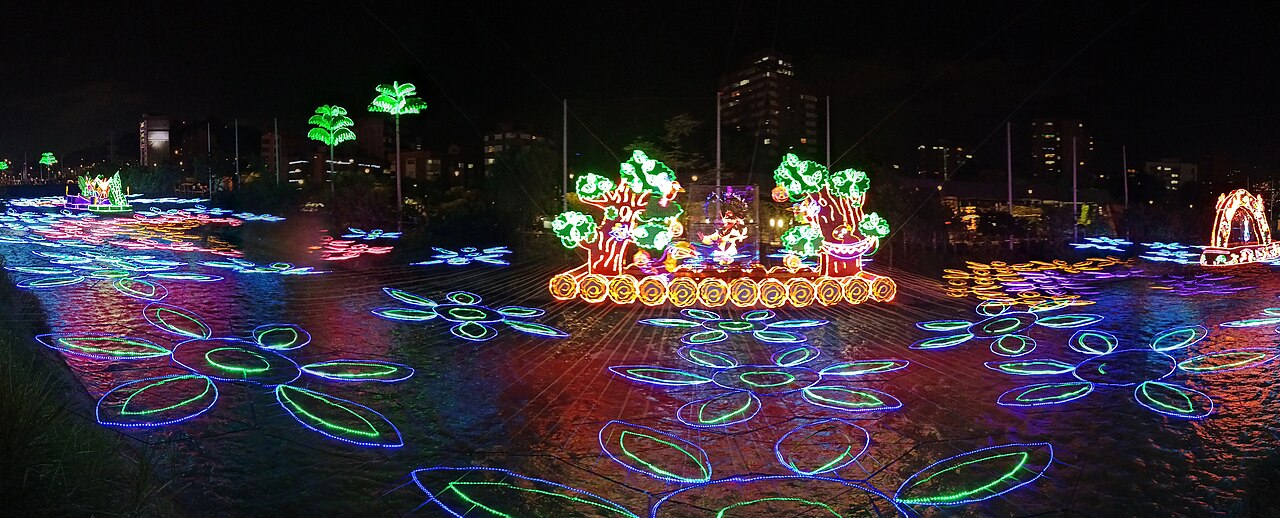 Christmas light figures glowing over the Medellín River at Parques del Río Medellín during the 2022 holiday lights festival