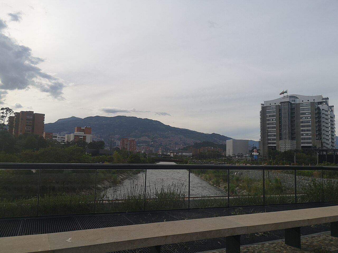 The Medellín River with re-vegetated banks seen from a park walkway at Parques del Río in May 2020