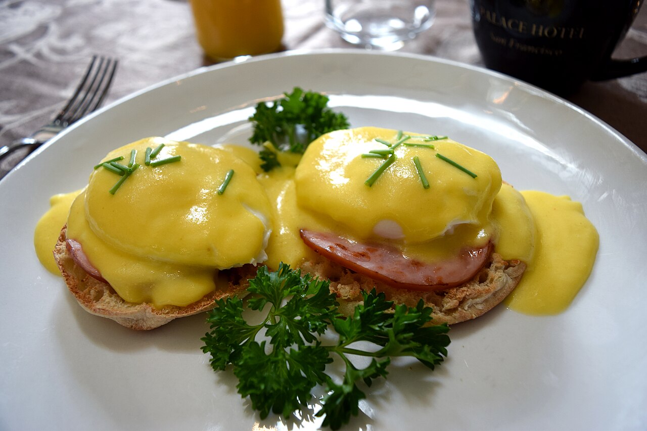 Traditional eggs Benedict with Canadian bacon and hollandaise sauce on an English muffin